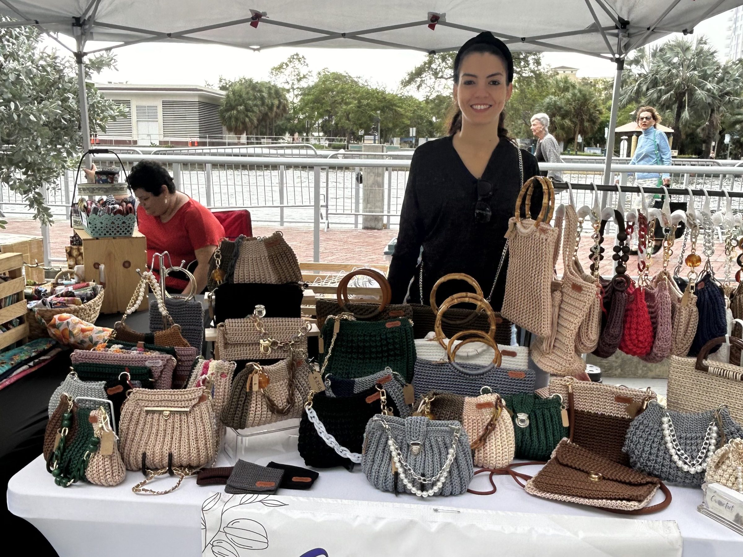 a group of people sitting at a table with an umbrella