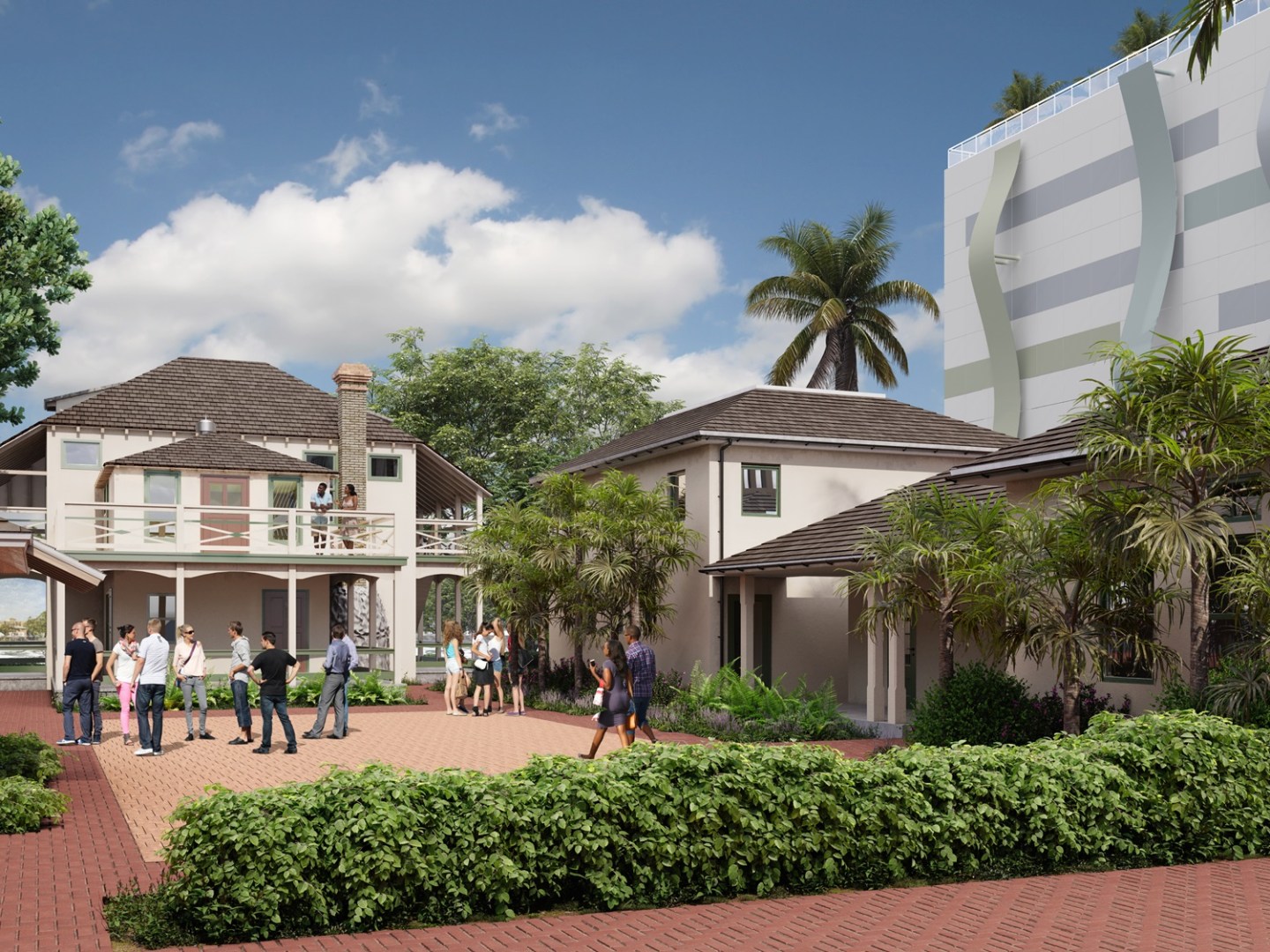 People gathered in a courtyard with buildings and palm trees.
